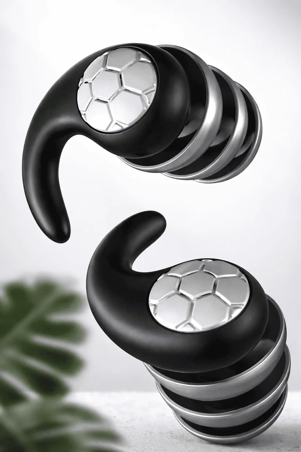 Black and silver earbud headphones on a light gray background