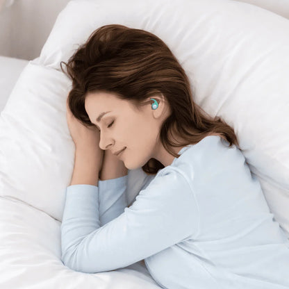 Woman sleeping with earplugs in a white bedroom
