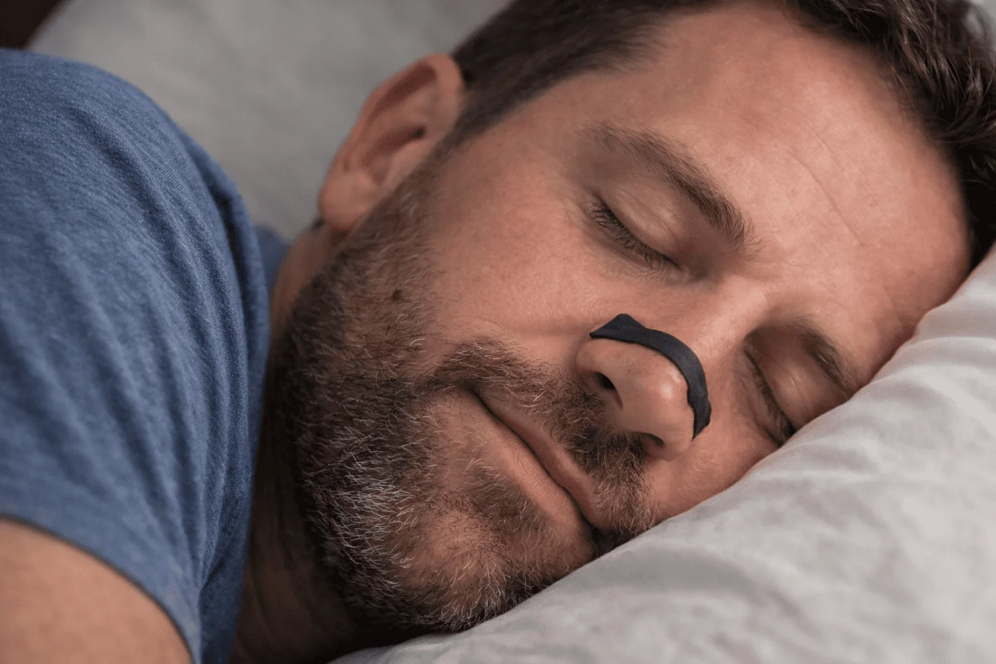 Man sleeping with a nasal device on his nose