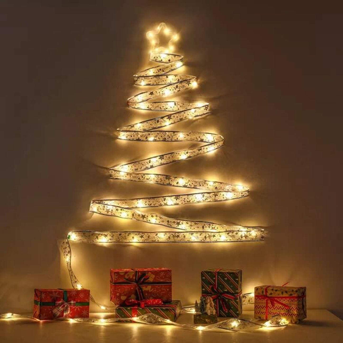 Decorative LED light tree with wrapped gifts on a neutral background
