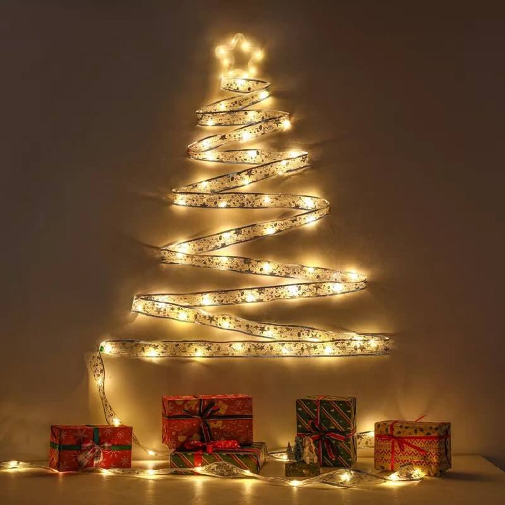 Decorative LED light tree with wrapped gifts on a neutral background