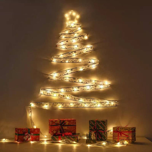 Decorative LED light tree with wrapped gifts on a neutral background