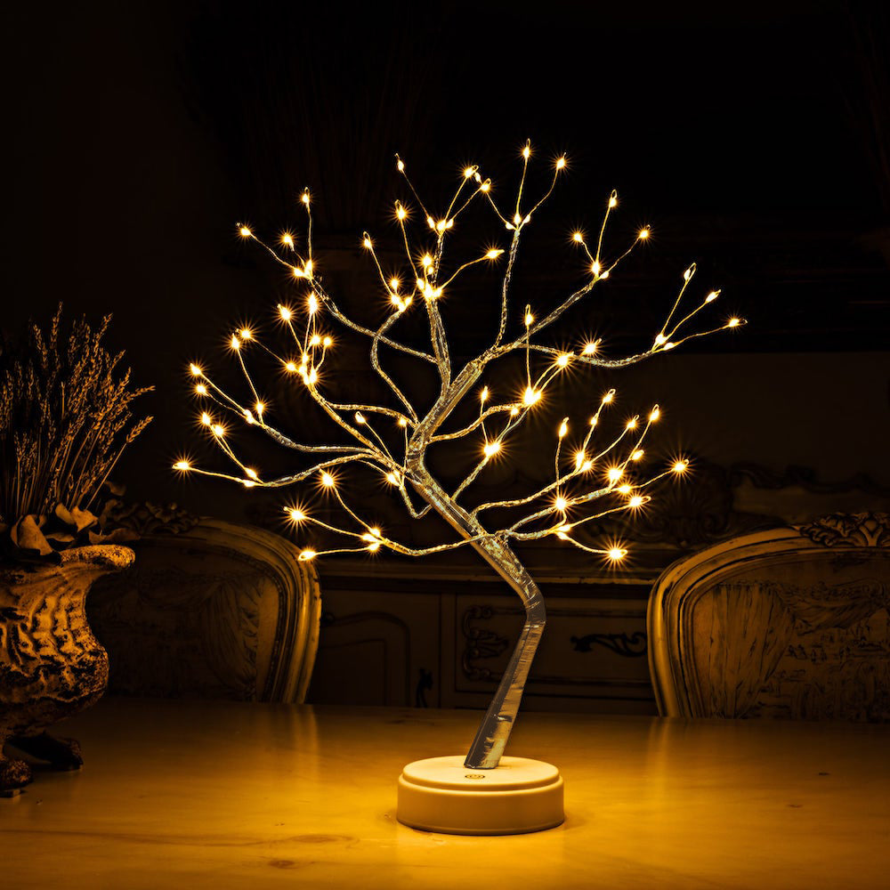 Decorative LED tree with warm light on a dark background