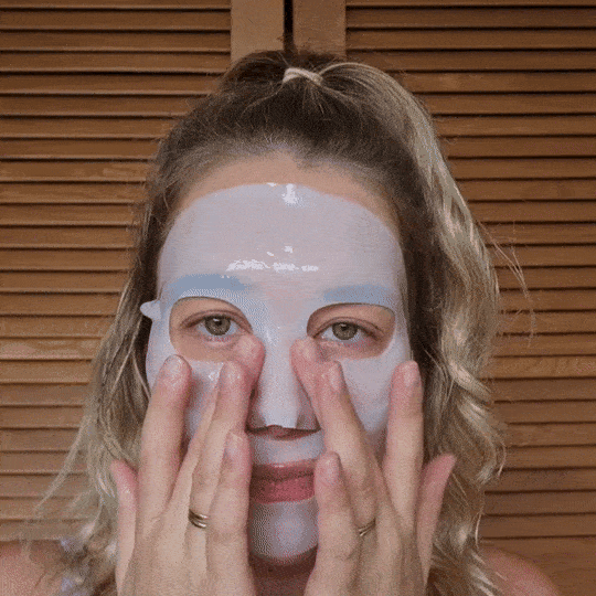Woman wearing hydrogel collagen mask and resting.