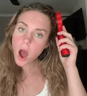 Person using LED scalp massager comb